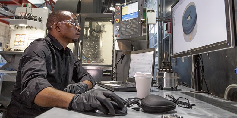 Man works with Autodesk software in a workshop