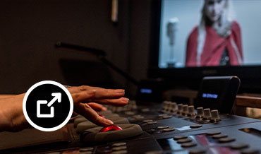 Close-up of artist’s hands using a colorist control panel