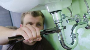 man repairing sink