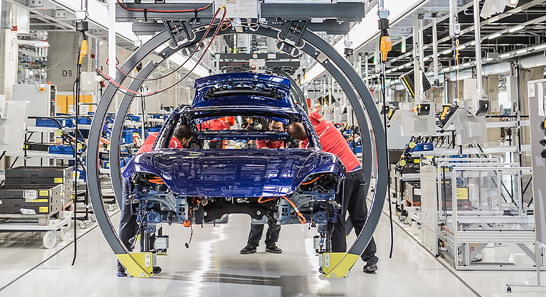 Several people assembling a car